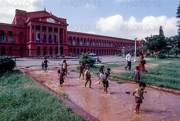 Children playing the rain water in front of High Court in Bengaluru Bangalore