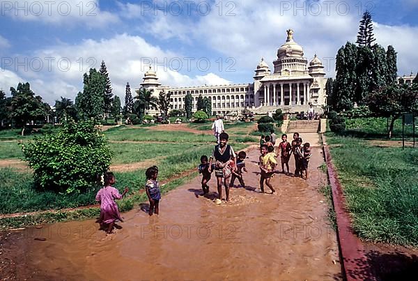 Children playing the rain water in front of Vidhana Soudha