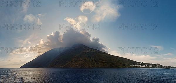 Stromboli volcano and island with the small fishing village of San Vincenzo with a circular smoke ring