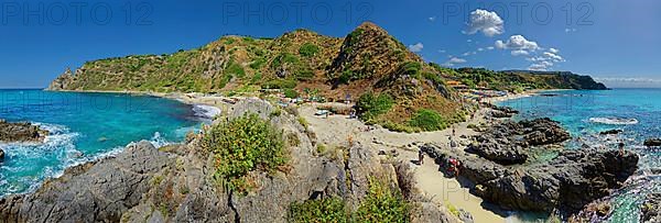 Panorama at the sandy beach and bay Capo Vaticano with turquoise sea and bizarre sky