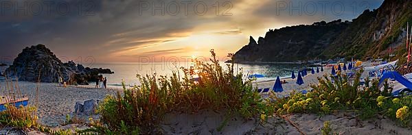 Panorama on the sandy beach and bay Capo Vaticano at sunset