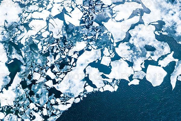 Droneview on a lake with floating ice sheet in the montain range Hemsedalfjell