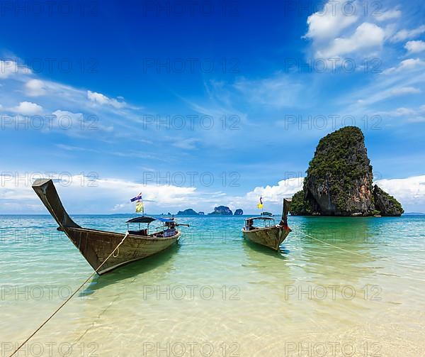 Long tail boats on tropical idyllic beach