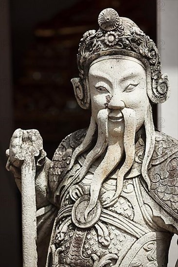 Chinese stone guardian statue close up in Wat Pho Buddhist Temple