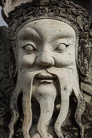 Wat Pho Chinese stone guardian face close up