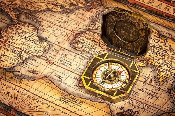 Vintage pirate retro compass on ancient world map