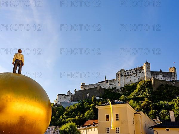 Man on golden sphere