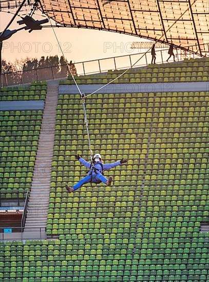 Woman swinging on a zip line above the Olympic Stadium