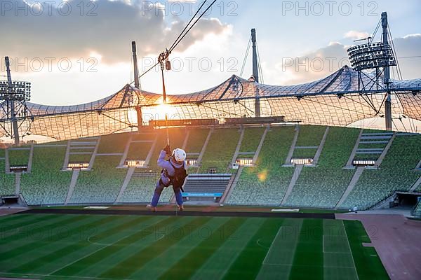 Woman swinging on a zip line above the Olympic Stadium