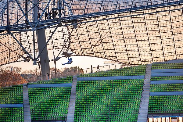 Woman swinging on a zip line above the Olympic Stadium