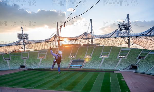 Woman swinging on a zip line above the Olympic Stadium