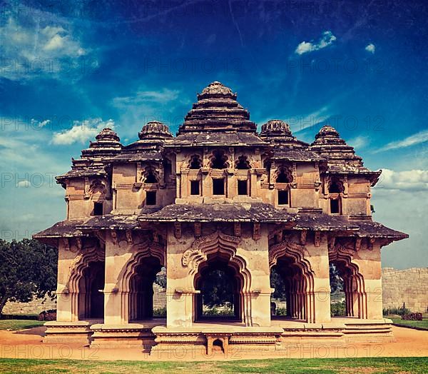 Vintage retro hipster style travel image of Lotus Mahal ruins with overlaid grunge texture. Royal Centre. Hampi