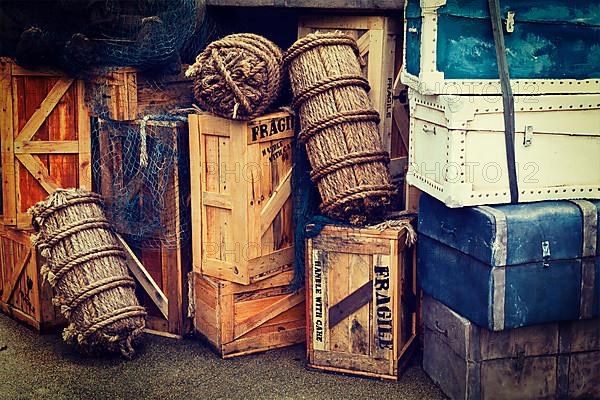 Retro hipster style travel image of vintage luggage and crates