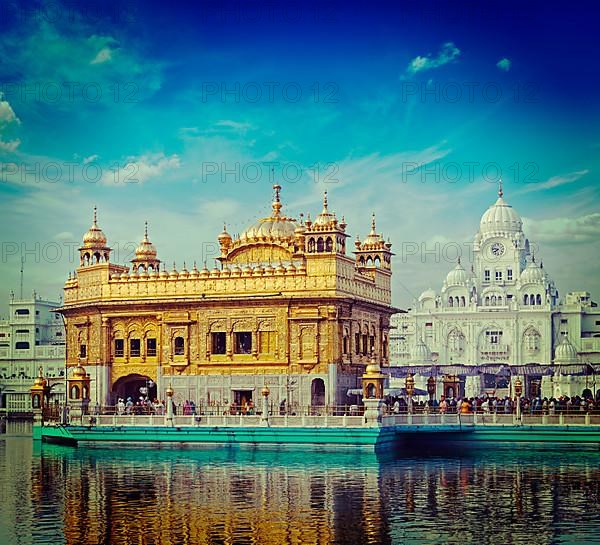 Vintage retro hipster style travel image of famous India attraction Sikh gurdwara Golden Temple