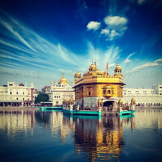 Vintage retro hipster style travel image of famous India attraction Sikh gurdwara Golden Temple
