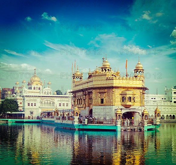 Vintage retro hipster style travel image of famous India attraction Sikh gurdwara Golden Temple