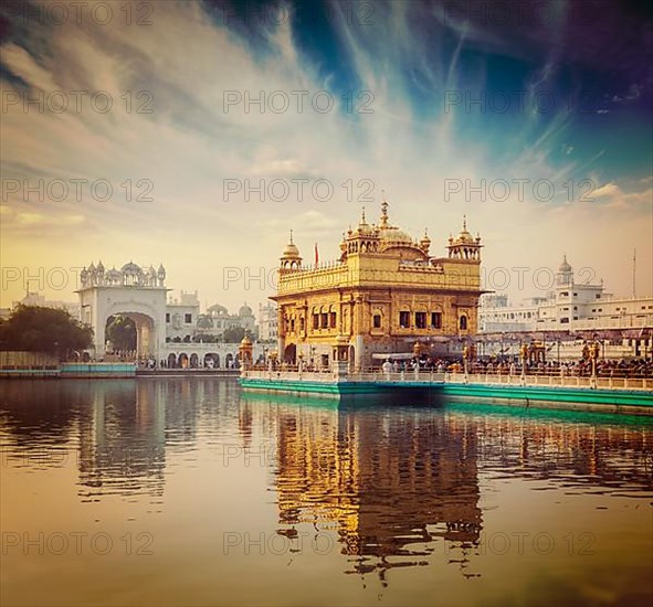 Vintage retro hipster style travel image of famous India attraction Sikh gurdwara Golden Temple