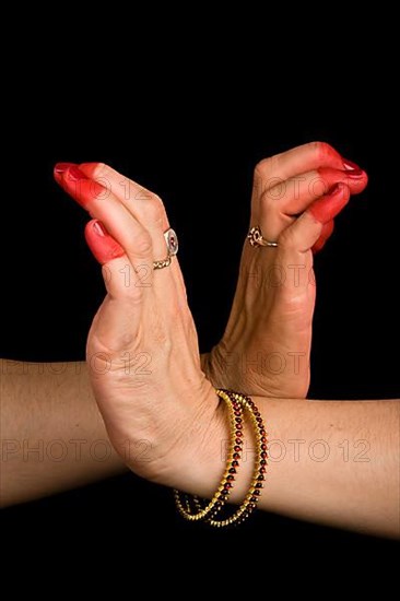 Woman hands showing Nagabandha hasta of indian classic dance Bharata Natyam