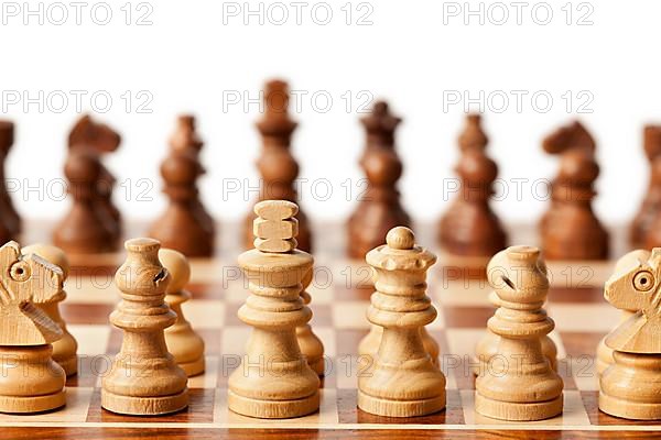 Wooden chess pieces on chessboard. Selective focus