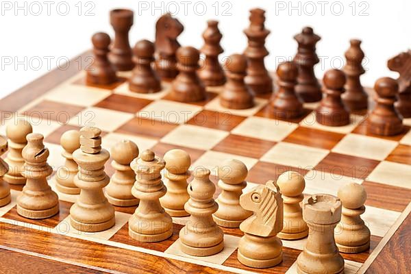 Wooden chess pieces on chessboard. Selective focus