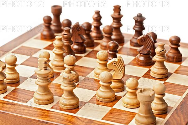 Wooden chess pieces on chessboard. Selective focus