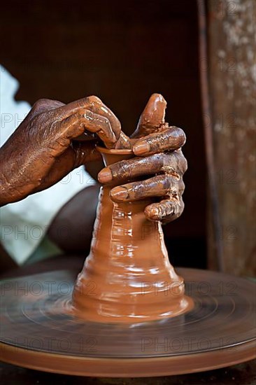 Potter throwing vase