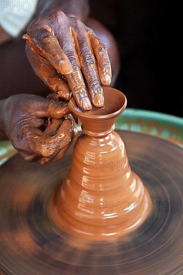 Potter throwing vase