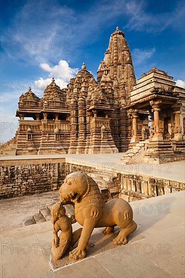 King and lion fight statue and Kandariya Mahadev temple. Khajuraho