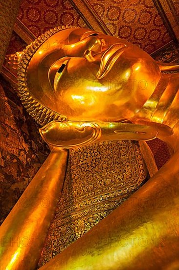 Reclining Buddha gold statue face. Wat Pho