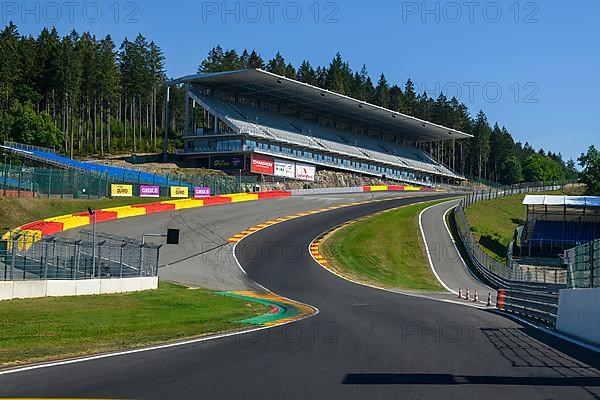 View from racing car perspective of racing driver while driving into dangerous curve Eau Rouge on 40 metres high driveway Raidillon of Circuit de Spa Francorchamps