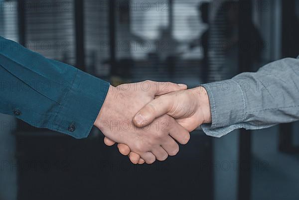 Close up of two business men shaking hands in the office