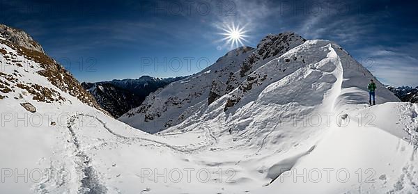 Hiker in snow at a saddle