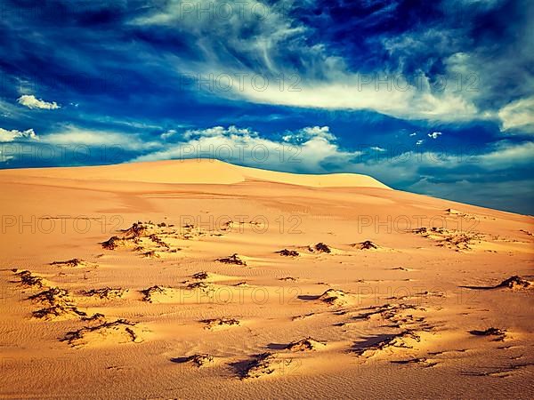 Vintage retro effect filtered hipster style image of white sand dunes on sunrise