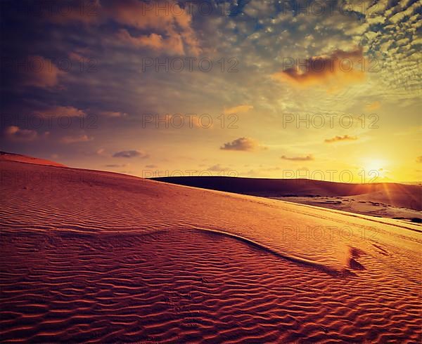 Vintage retro effect filtered hipster style image of white sand dunes on sunset