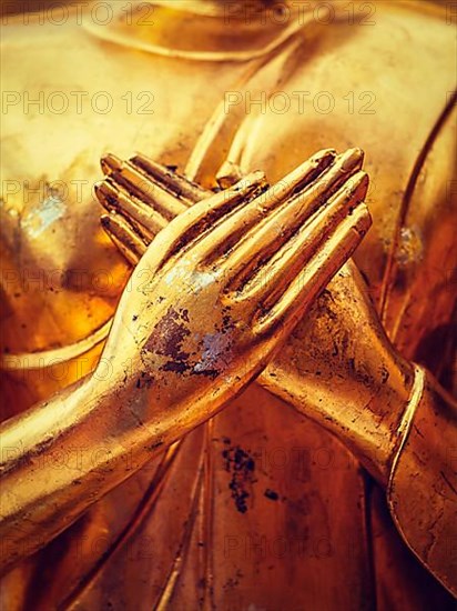 Vintage retro effect filtered hipster style image of gold Buddha statue hands close up in Wat Phra That Doi Suthep