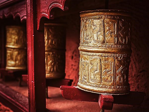 Vintage retro effect filtered hipster style image of Buddhist prayer wheels in Thiksey gompa