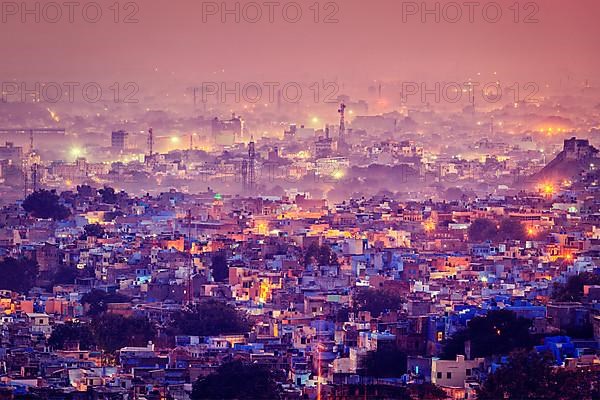 Vintage retro effect filtered hipster style image of Jodhpur aka Blue City due to the vivid blue-painted Brahmin houses around Mehrangarh Fort in the evening twilight. Jodphur