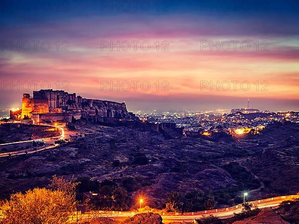 Vintage retro effect filtered hipster style image of famous indian tourist landmark Mehrangarh fort in twilight. Jodhpur