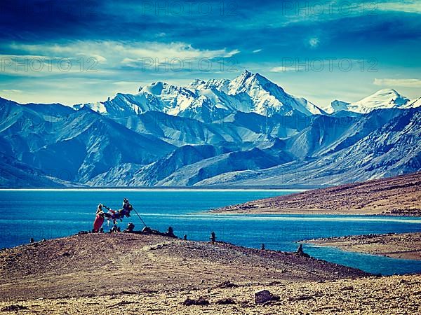 Vintage retro effect filtered hipster style image of Buddhist prayer flags lungta at Himalayan lake Tso Moriri in the morning. Korzok