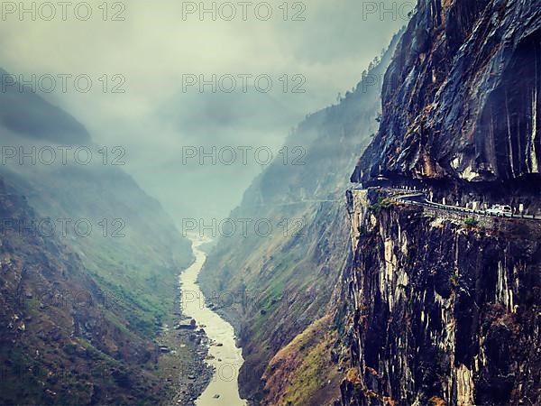 Vintage retro effect filtered hipster style image of car on dangerous road in Himalayas mountains in gorge above precipice