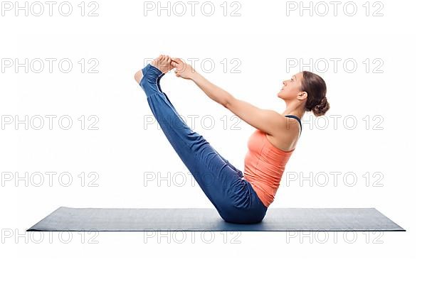 Beautiful sporty fit woman practices yoga asana Ubhaya padangusthasana