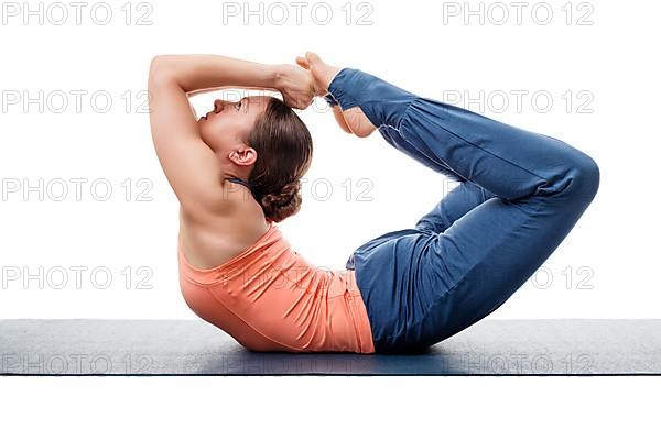 Sporty fit woman practices yoga asana Dhanurasana