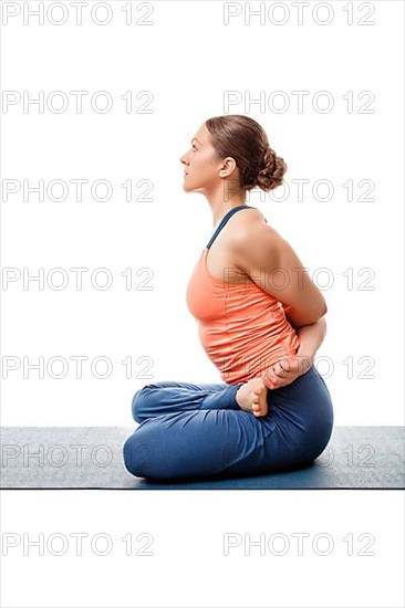 Sporty fit woman doing Ashtanga Vinyasa yoga asana Baddha Padmasana