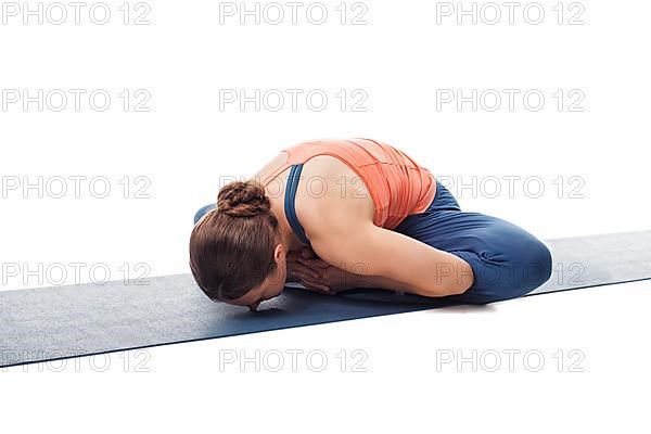 Beautiful sporty fit woman practices yoga asana Baddha konasana