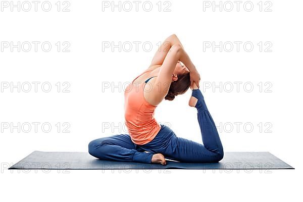 Sporty fit yogini woman doing yoga asana Eka pada kapotasana