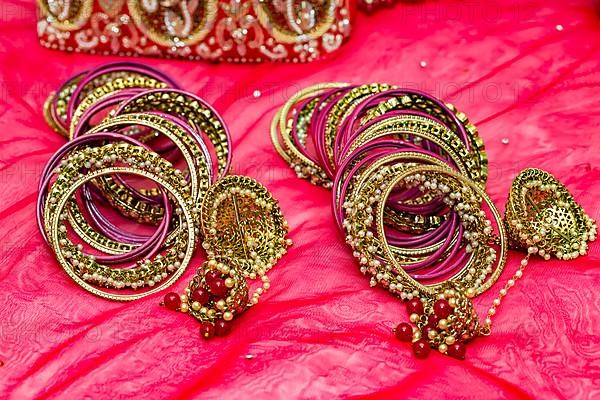 Closeup of Hindu brides bangles on red