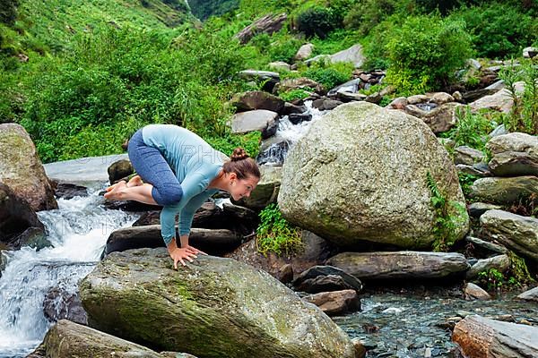 Woman doing Kakasana asana