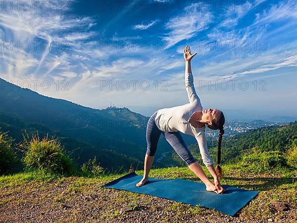 Woman doing Ashtanga Vinyasa yoga asana Utthita trikonasana