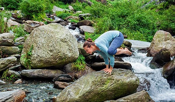 Woman doing Kakasana asana