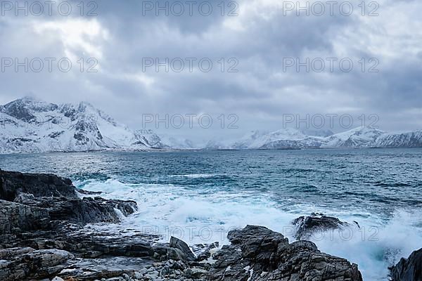 Waves of Norwegian sea crushing at rocky coast in fjord. Vikten